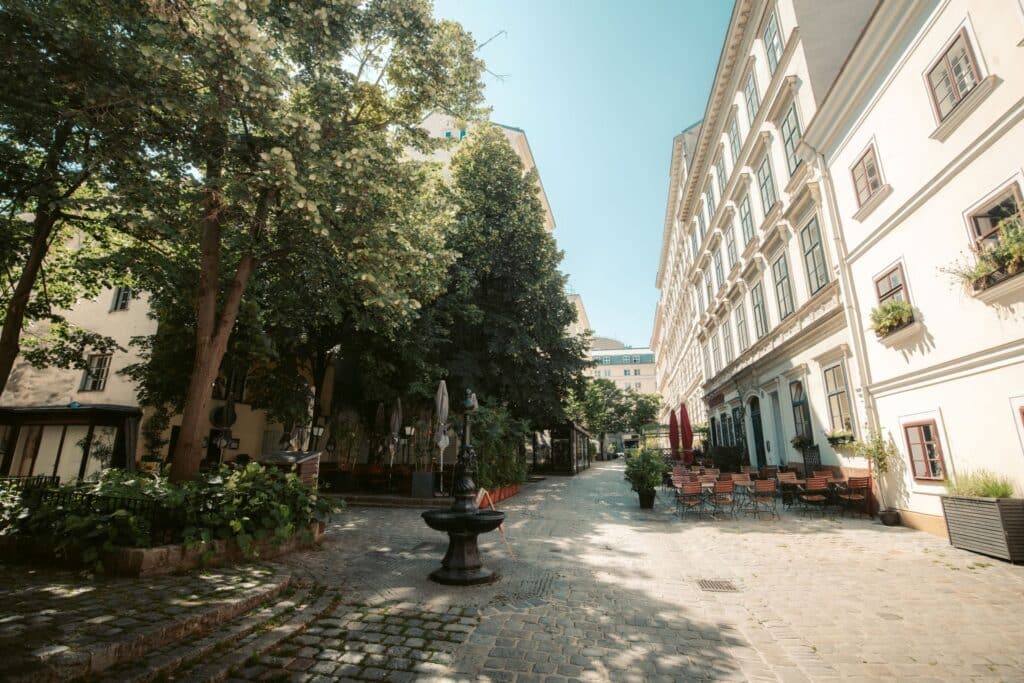 innenhof mit gastgarten im sommerlichen wien