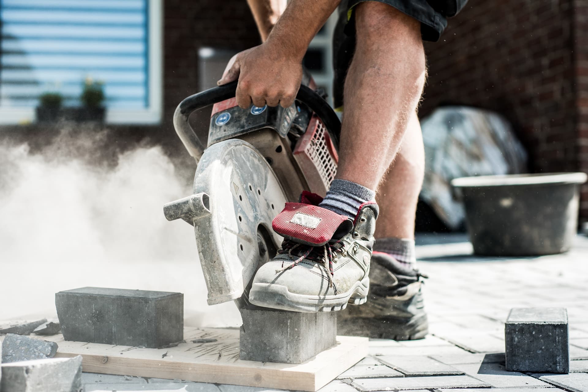 Handwerker schneidet Steinplatten für Gartenbau | Steingarten